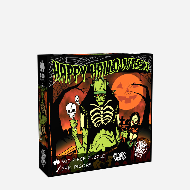 Product packaging front. Illustration, orange, green, black and white scene. Green frankenstein-like creature, vampire woman holding a black cat, and a skeleton wearing a white shroud, standing on a porch trick or treating. Black bare trees and an orange Jack o'lantern face moon in the background. Green text at top reads Happy Halloween. White text reads 500 piece puzzle, Eric Pigors. White Trick or Treat Studios logo. 