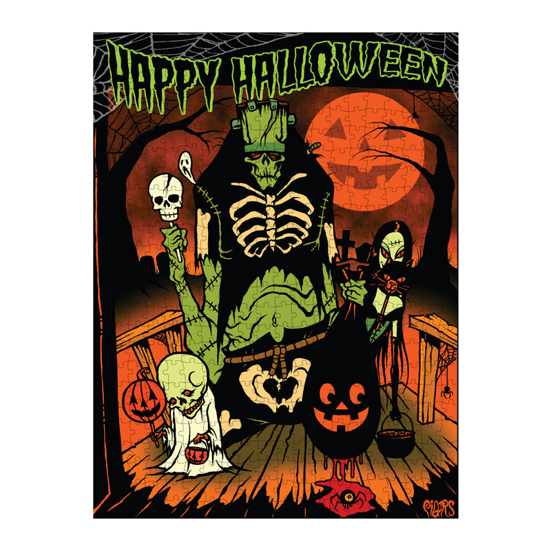 completed puzzle. Illustration, orange, green, black and white scene. Green frankenstein-like creature, vampire woman holding a black cat, and a skeleton wearing a white shroud, standing on a porch trick or treating. Black bare trees and an orange Jack o'lantern face moon in the background. Green text at top reads Happy Halloween.