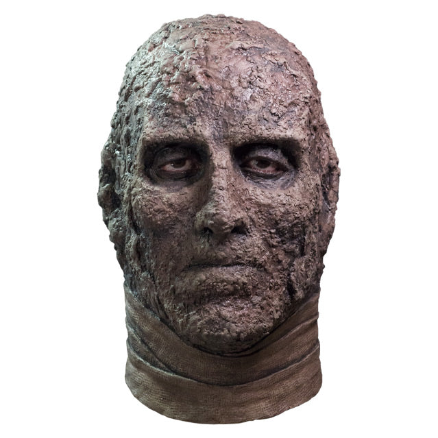 Mask, front view, head and neck, Brown dried flesh, expressionless face, gray bandages around neck.