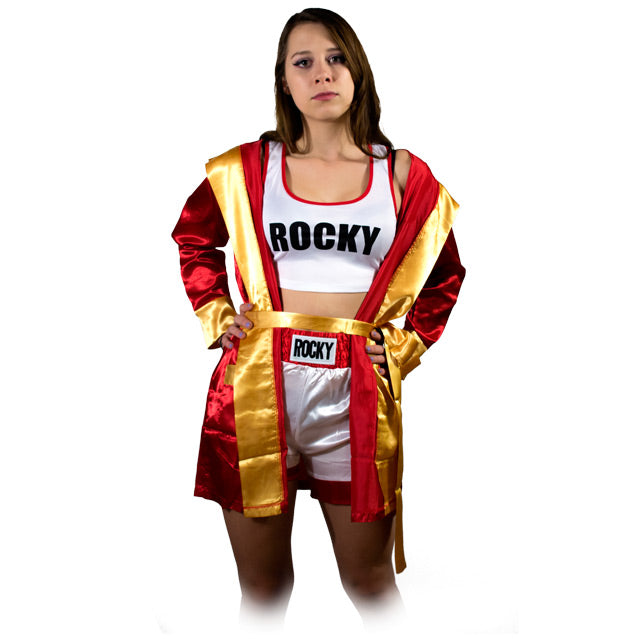 Front view, woman wearing short, hooded, red satin robe, gold trim and cuffs. over white and orange boxing trunks, black text reads Rocky. White tank top red trim, black text reads Rocky.