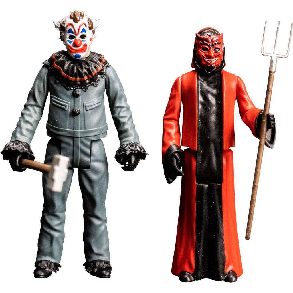 Two 3.75 inch figures. Clown, White clown face, brown hair on top and sides of head. Exaggerated red eyebrows, nose, and smiling mouth. Blue above and below eyes and on chin. Wearing gray clow suit with black ruffles on collar and cuffs, holding sledgehammer prop.  Devil, Red devil face, black hair, eyebrows, moustache and goatee. Maroon horns, outlines around eyes, nostrils and earlobes. Pink upper ears and lips. Pointed yellow teeth. Wearing red and black robes, holding pitchfork prop.