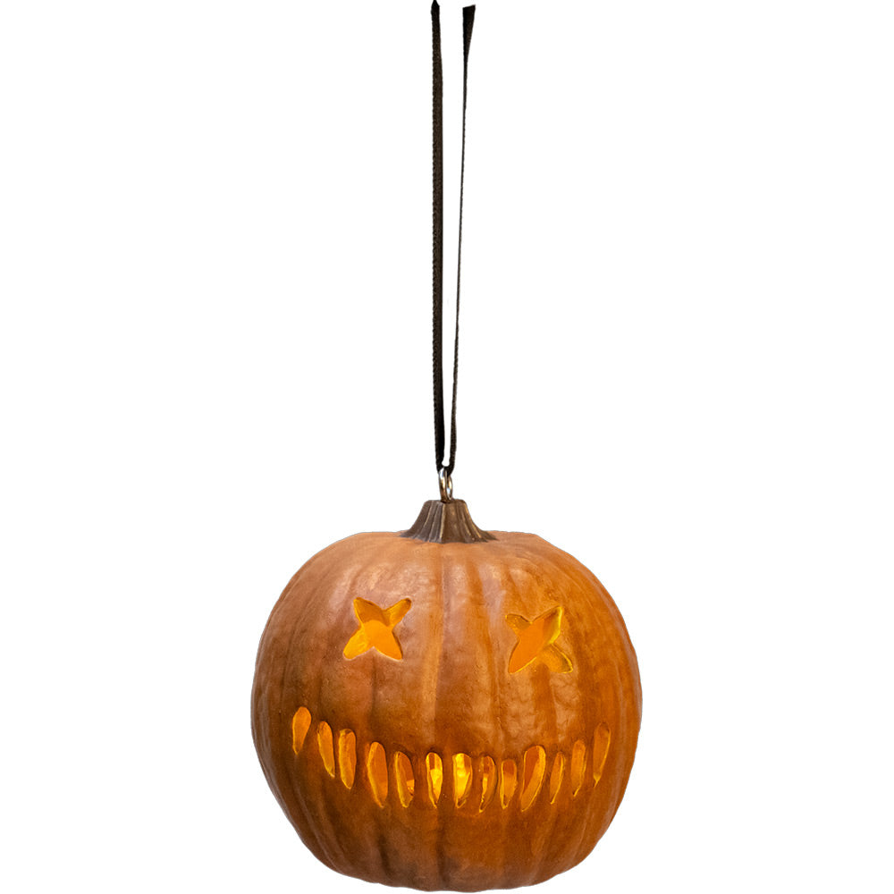 Ornament.  Orange jack o' lantern, two x eyes, several straight hash marks for mouth, lit up.