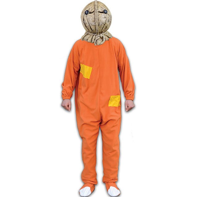 Costume.  Person wearing Sam Burlap mask, orange footy pajamas with yellow patches on body, white patches on toes.