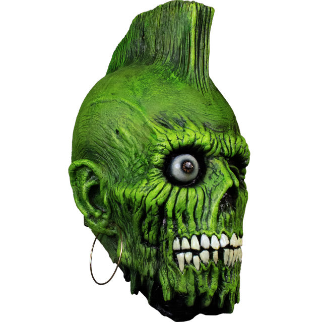 Mask, right view. Green wrinkled and rotting flesh, Green mohawk on top of head. Brown right eye with no eyelids, left eye socket empty. skeletal lower face, crooked and broken white teeth. Large hoop earring in right ear.
