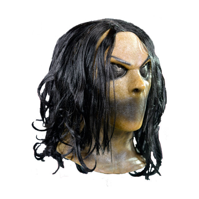 Mask, head and neck, right side view. Long black hair. Black thin eyebrows. Black closed eyes. No mouth, flat black skin where mouth would be. Discolored flesh on neck and upper chest..