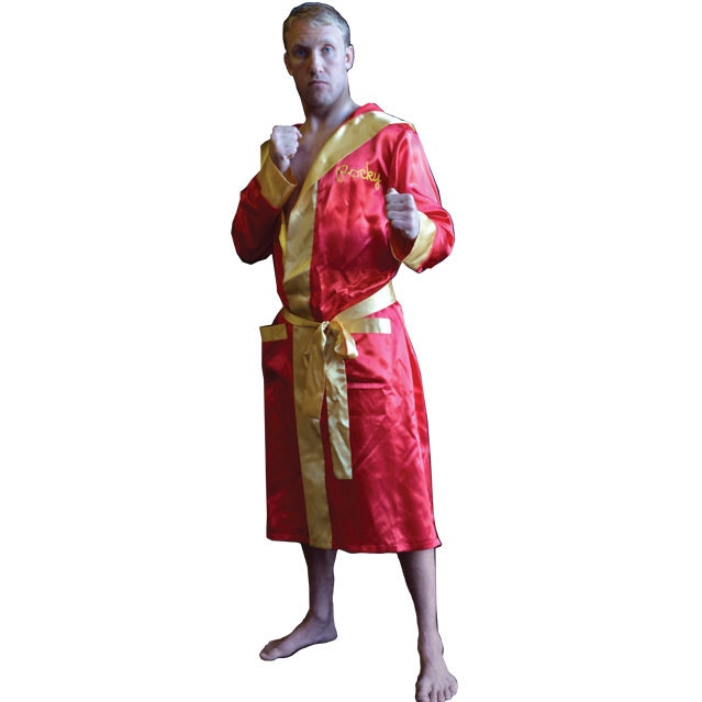 Front view, person wearing red satin robe, gold trim and cuffs.