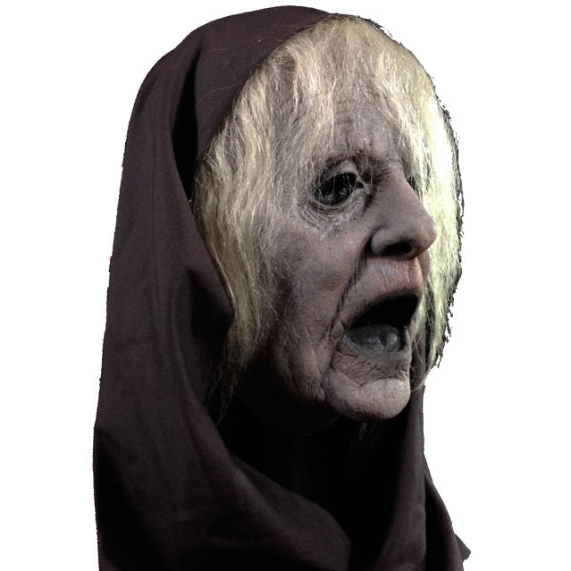 Mask, right view. Long white hair, wrinkled grayish skin, wide open mouth. Wearing black hood.