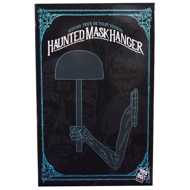 Product packaging, front. Black box with blue decorative border, illustrations of three masks in background. Illustration of mask hanger. Blue text at top reads Official Trick or Treat Studios, White text below reads Haunted Mask Hanger.  White Trick or Treat Studios logo, bottom right corner.