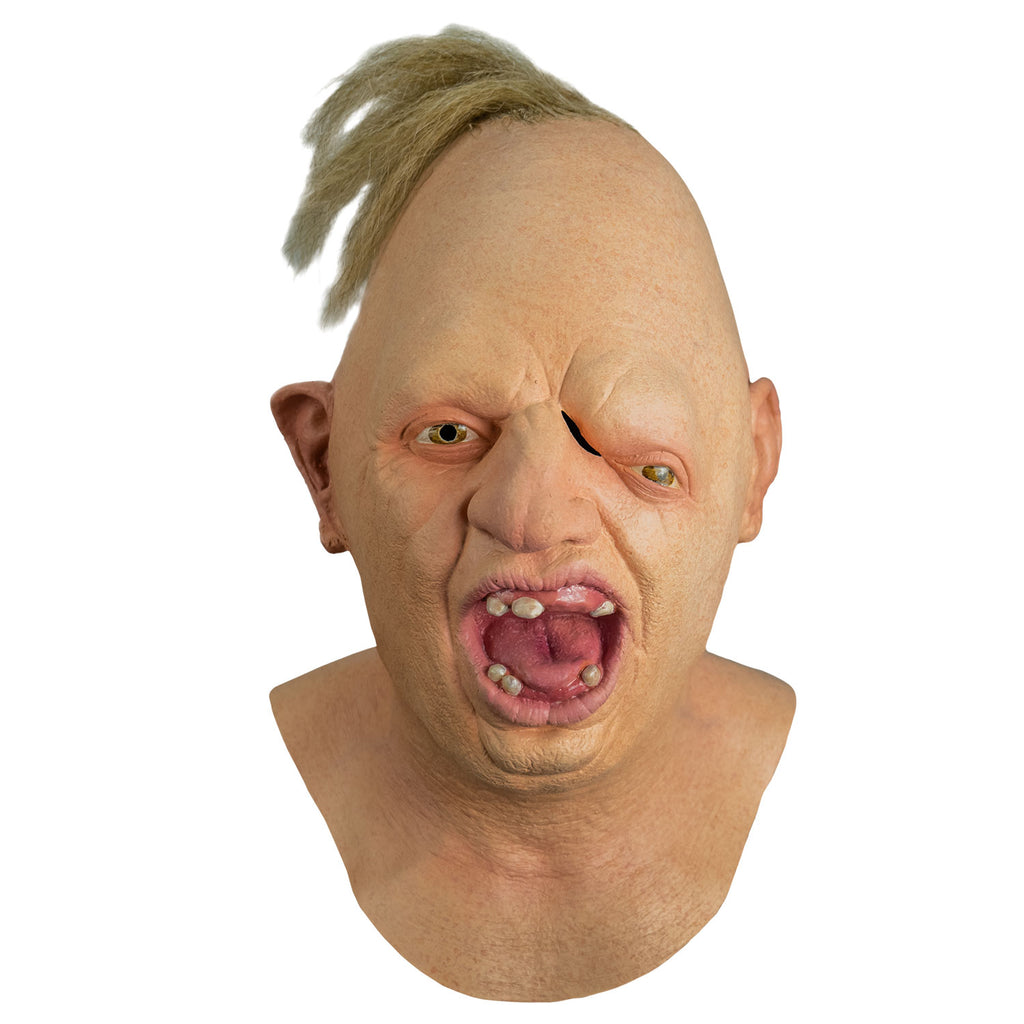 Mask, front view, head, neck and upper chest.  Egg shaped head, tuft of disheveled blond hair on top.  No eyebrows, light brown eyes offset, left eye lower than the right.  Large crooked nose.  Deformed right ear.  Mouth wide open showing pink tongue and gums and only 6 teeth.