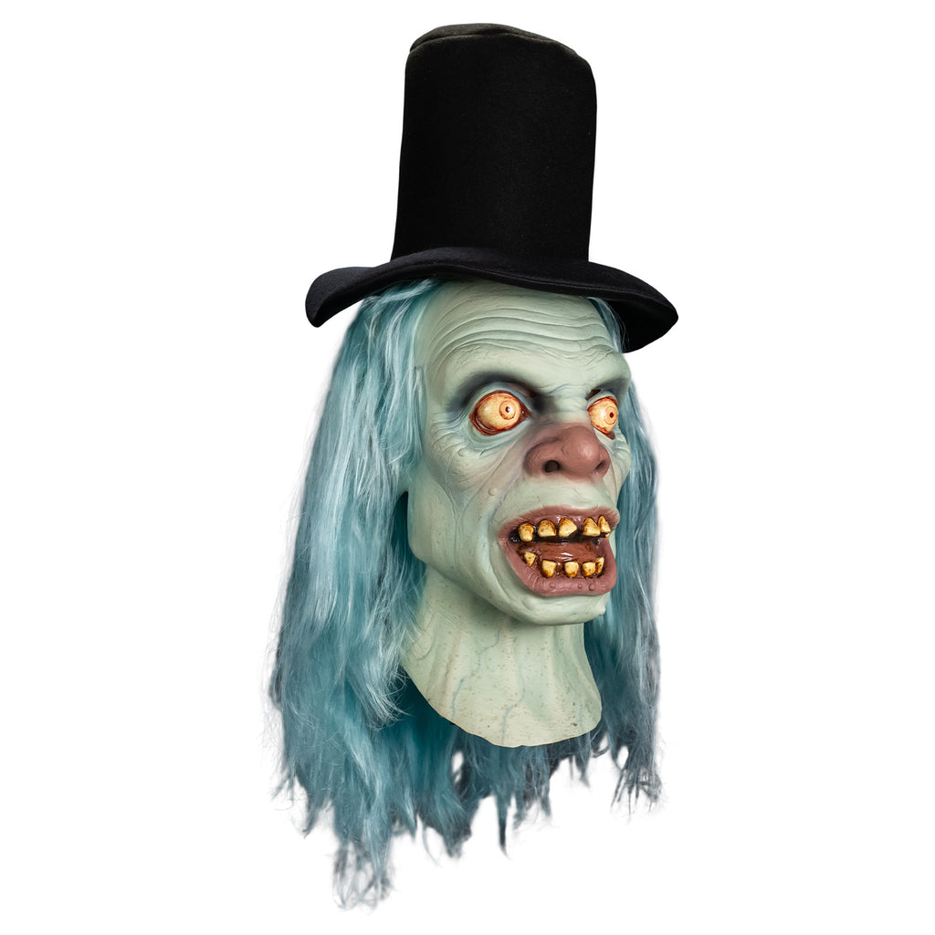 Mask right side view, head and neck. Black top hat. Long, straight, light blue hair. Pale blue wrinkled skin. No eyebrows, large, wide open, bloodshot yellow eyes. Large, bulbous pink nose. Mouth, wide open showing tongue and dirty yellowed teeth, large pink lips. blue veins showing on neck.