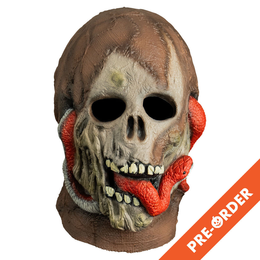 white background, orange diagonal banner bottom right, white text reads pre-order. mask, front view, head and neck. dried mummy flesh on top of head and neck, skull face, red-orange snake twisted through ears and under jaw, snake head protruding from mummy's mouth.