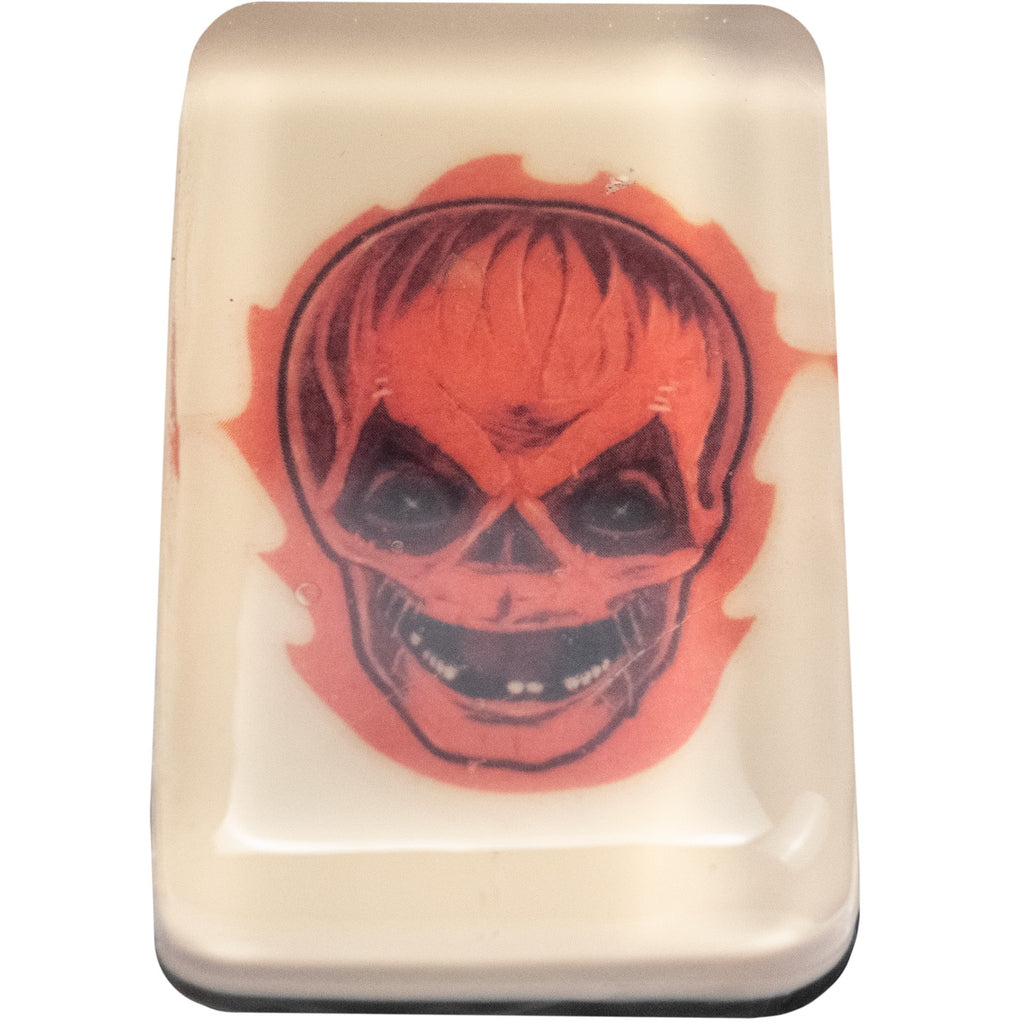 Bar soap.  White, with illustration of Trick 'r Treat Sam unmasked head under clear soap layer.  Flaming orange jack o' lantern skull face.