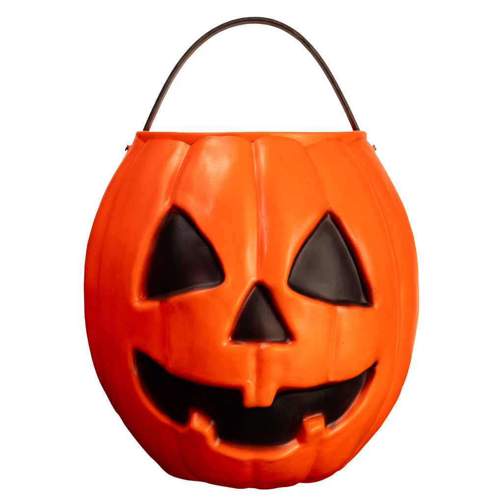 front view pumpkin candy pail. Orange Jack o' lantern face. black eyes nose and face. Black handle at top.