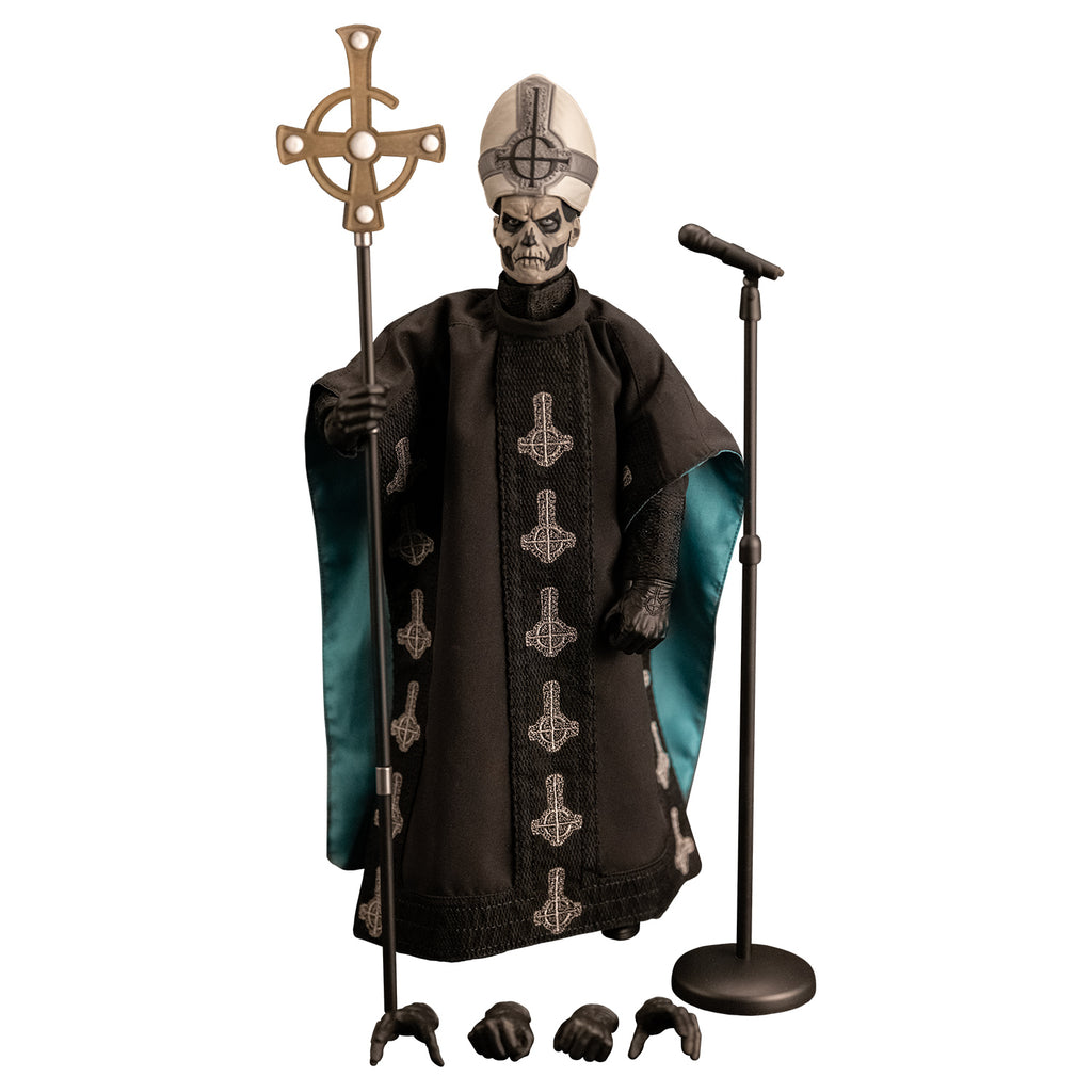 White background. Figure and accessories. Black and white skull-like face wearing black and silver, tall hat adorned with black inverted cross with semi circle that looks like a G. wearing black floor-length robe green on the inside adorned with several white inverted crosses, with semi circle that looks like a G.  black gloves and black boots.  Holding black staff topped with inverted gold cross.  4 additional accessory hands, microphone and stand