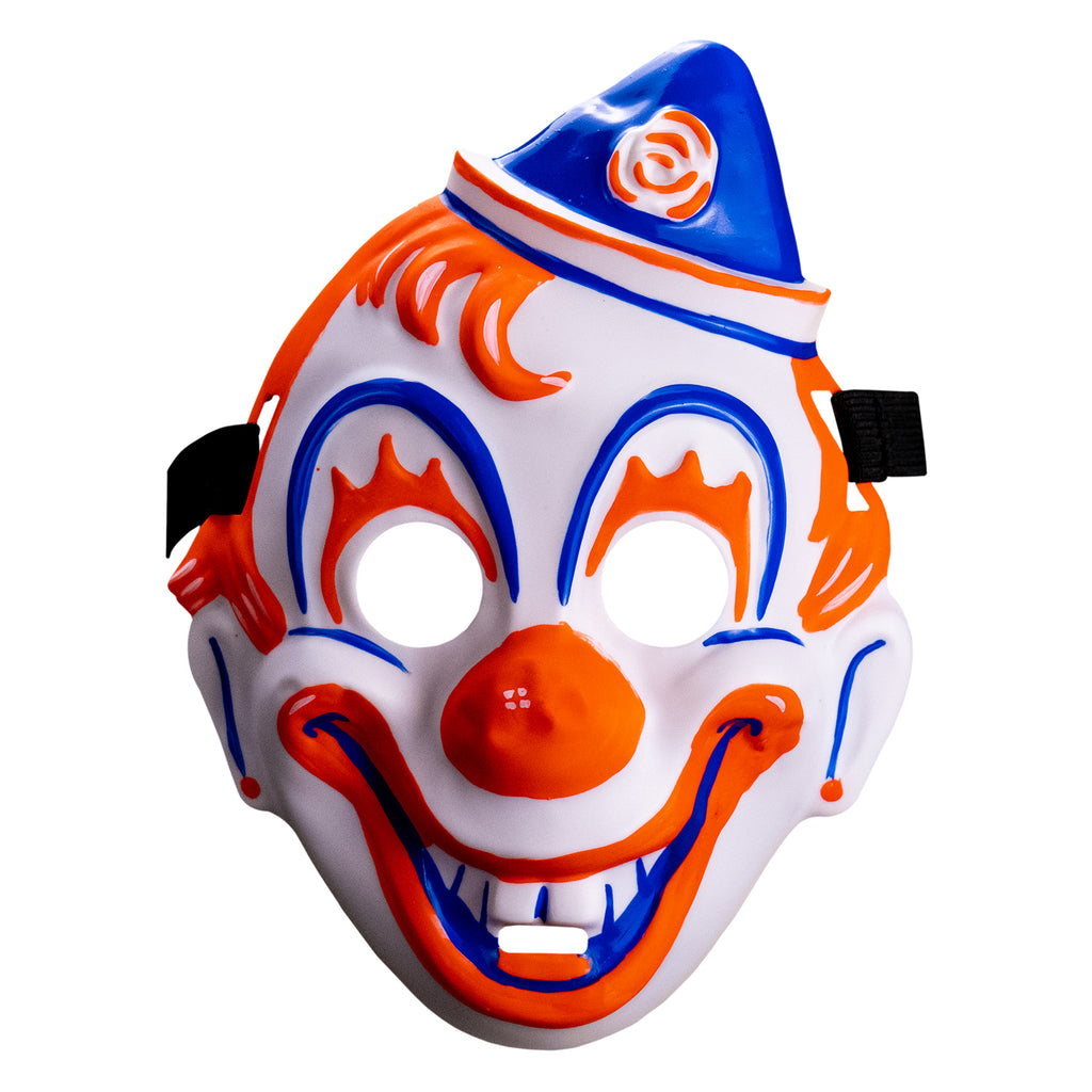 Face mask, front view.  white clown face, blue white and orang triangular hat tipped to the left . orange painted hair.  Blue arches around eyes, orange painted eyelashes, blue lines on cheeks and ears, orange dots on earlobes, large orange clown nose.  Orange and blue clown mouth in a large smile showing teeth. Black elastic strap at temples