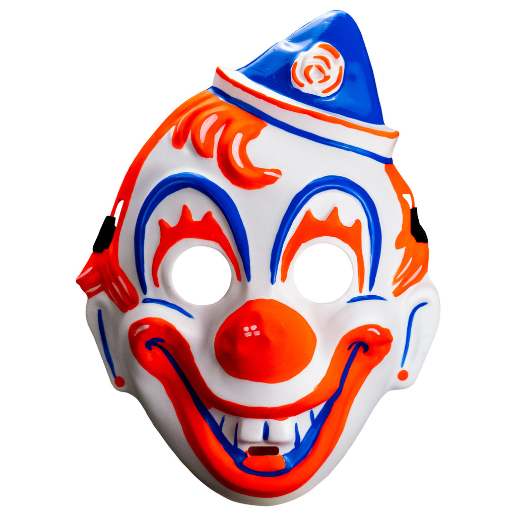 Face mask, front view. white clown face, blue white and orang triangular hat tipped to the left . orange painted hair. Blue arches around eyes, orange painted eyelashes, blue lines on cheeks and ears, orange dots on earlobes, large orange clown nose. Orange and blue clown mouth in a large smile showing teeth. Black elastic strap at temples
