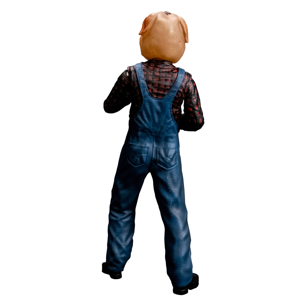 8 inch figure back view. Person with bloodied pig head mask. Wearing flannel print shirt, blue overalls, black boots. 
