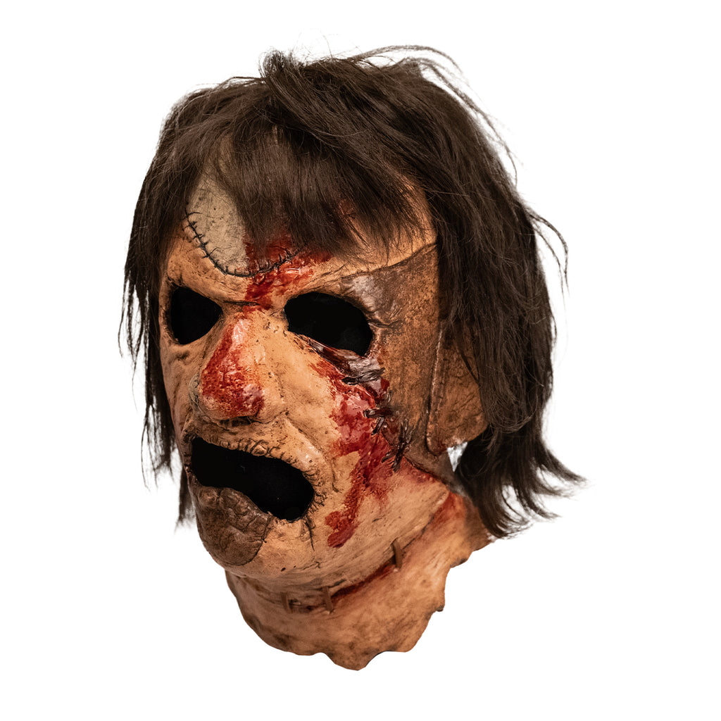 Leatherface latex mask with hair and faux blood splatter, side view