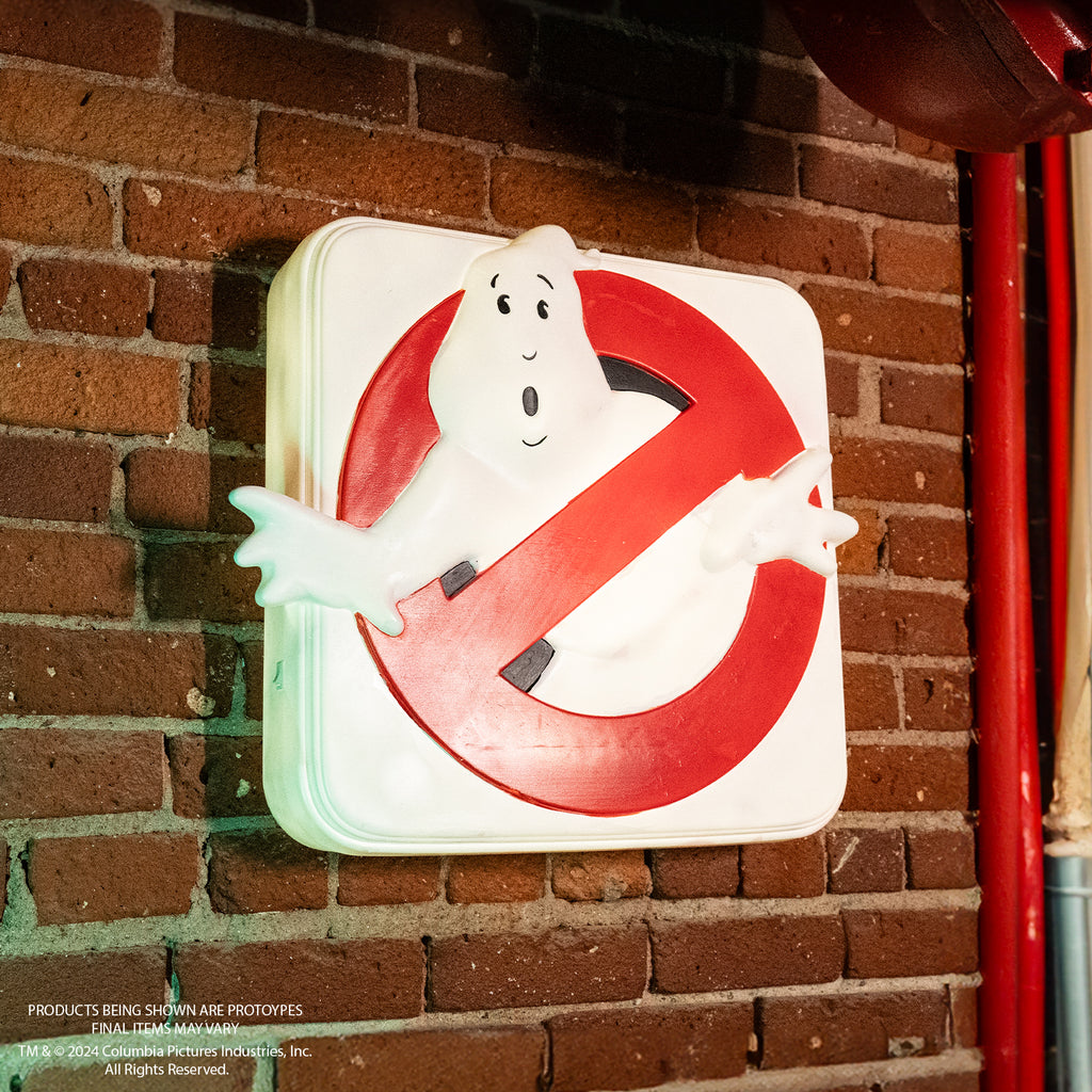 White square light up sign mounted on wall. White ghost in red crossed circle.