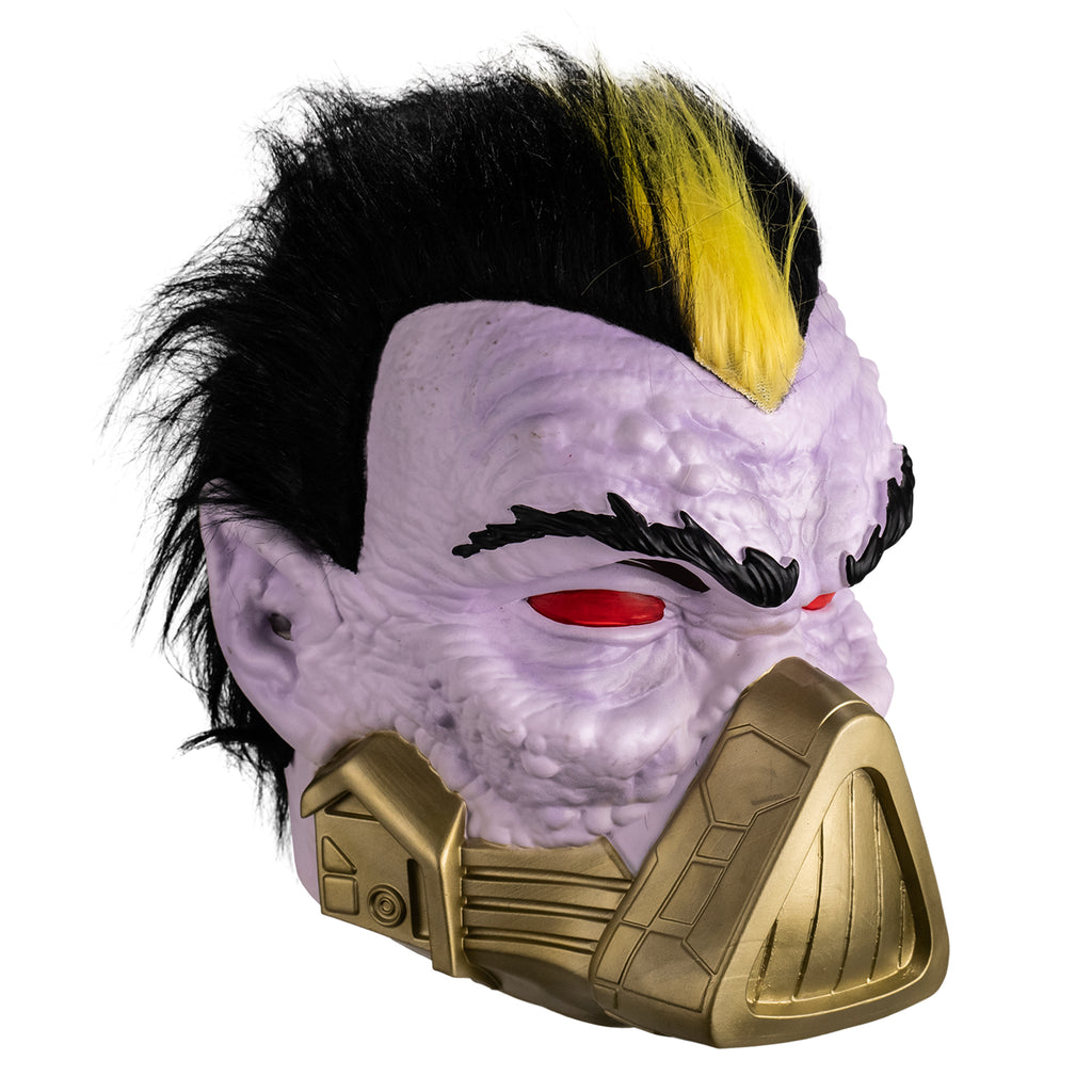 Mask, right side view. Short black hair, yellow stripe in the center front. Pale purple bumpy flesh. Black bushy eyebrows, red eyes. gold mask, triangular over nose and mouth, horizontal bands around lower jaw. Pointed ears.
