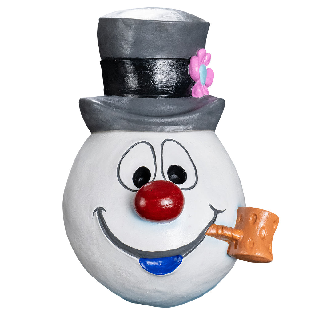 Mask, front view.  Cartoonish, white round snowman head, wearing a gray top hat with a black band and a pink flower on the left side. Face has large cartoon eyes, round red nose, gray cartoon mouth with blue bottom lip, tan pipe in the left corner of mouth.  