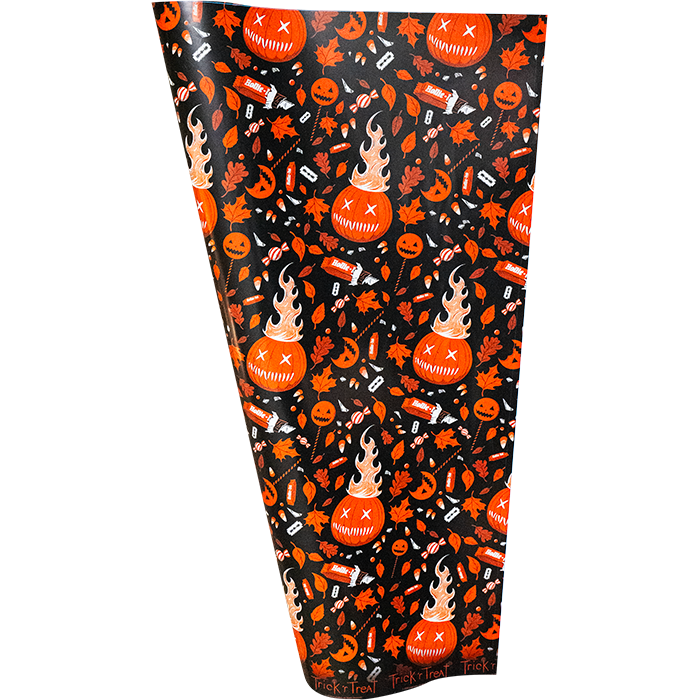 Wrapping paper.  Repeating orange, red and white pattern of flaming jack o' lanterns, leaves, candy and lollipops on black background.
