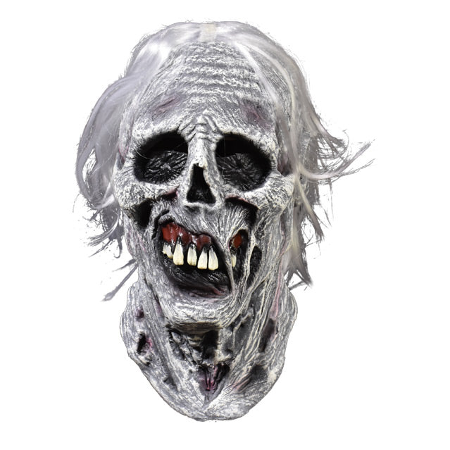 Front view. Chiller mask. White and grey skeletal face with wrinkled and rotten flesh, black eye sockets, prominent teeth in dark red gums. bright white hair.