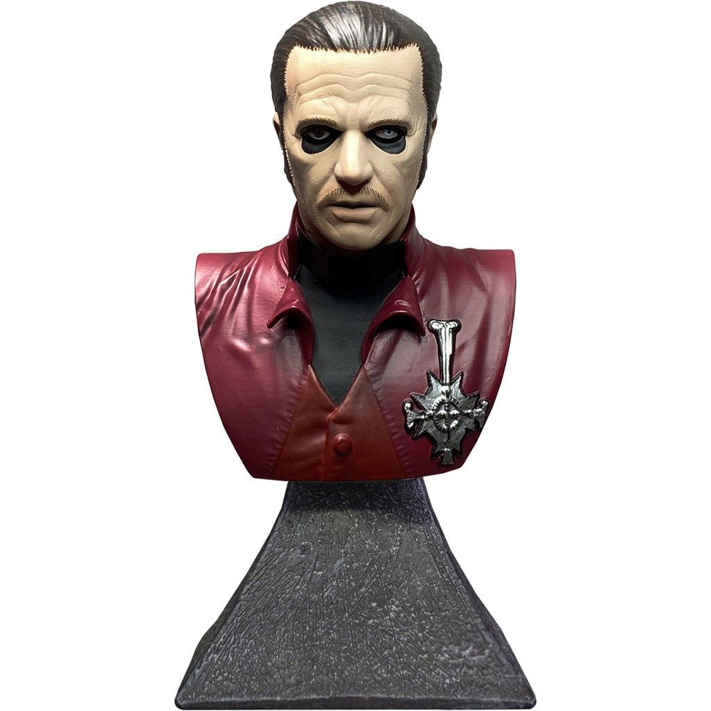 Ghost Cardinal Copia mini bust, front view.  Head, neck and chest of man.  Slicked back dark brown hair with gray streak, black-rimmed eyes, left eye blue, right eye black.  Wearing black shirt under red jacket with silver medallion on left of chest.  Bust is set on stone textured base.