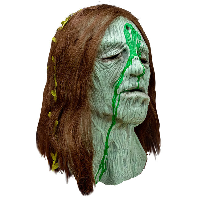 Right side view, Creepshow Becky Mask, Zagone edition. Head and neck of woman. Red brown straight hair, with seaweed in it, green wrinkled mossy skin, eyes appear closed. hole in forehead oozing dried green fluid.