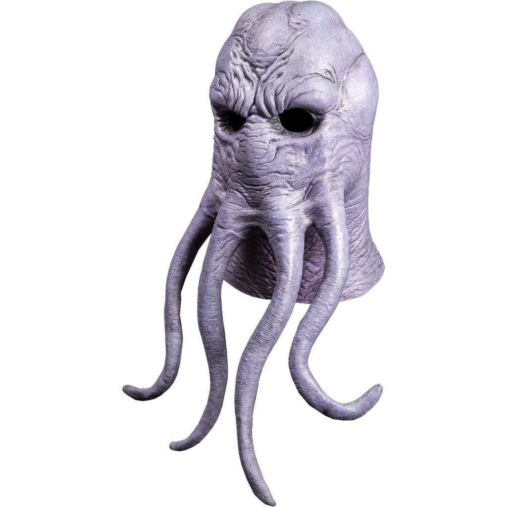 Mask, left side view, head and neck. Lumpy octopus-like head, wrinkled gray flesh. Four long tentacles extending from middle of face.