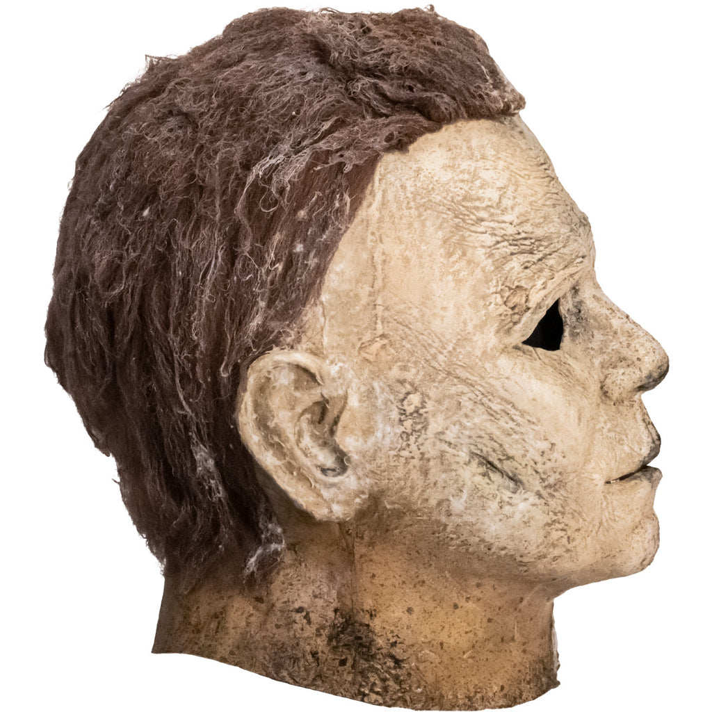Right side view. Mask, head and neck. Brown hair, weathered, dirty moldy skin.