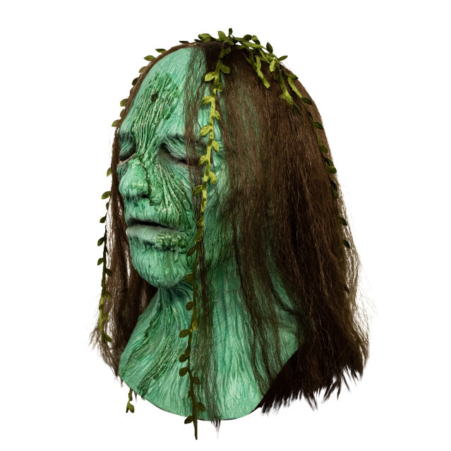 Left side view, Creepshow Becky Mask. Head and neck of woman. Red brown straight hair, with seaweed in it, green wrinkled mossy skin, eyes appear closed. hole in forehead.