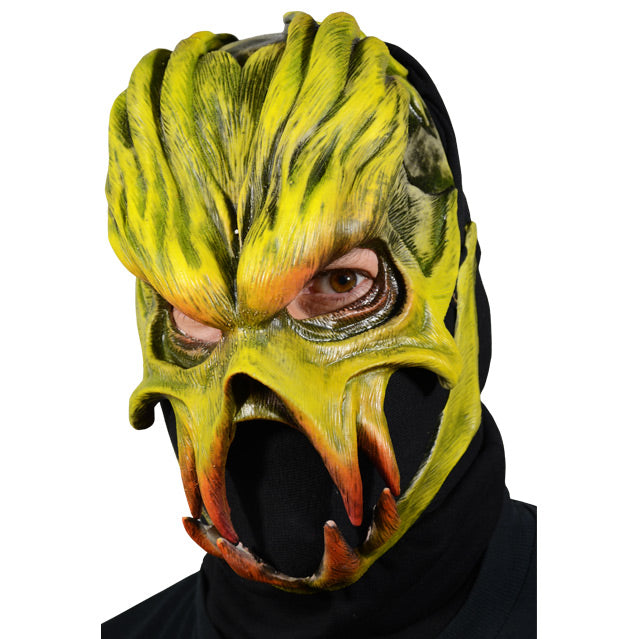 Man wearing mask, Alien with heavy brows, prominent cheek bones and jaw. Yellow with hints of orange around eyes and teeth.
