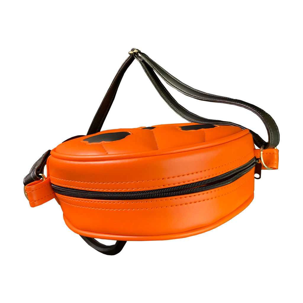 Bag. overhead view of top zipper. Round orange and black, jack o' lantern face. Black adjustable strap.