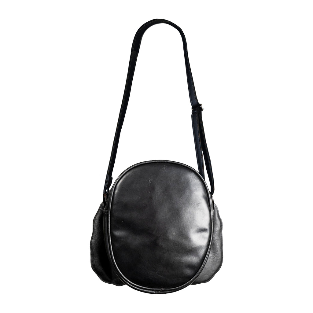 Back of bag, all black, with black adjustable strap.
