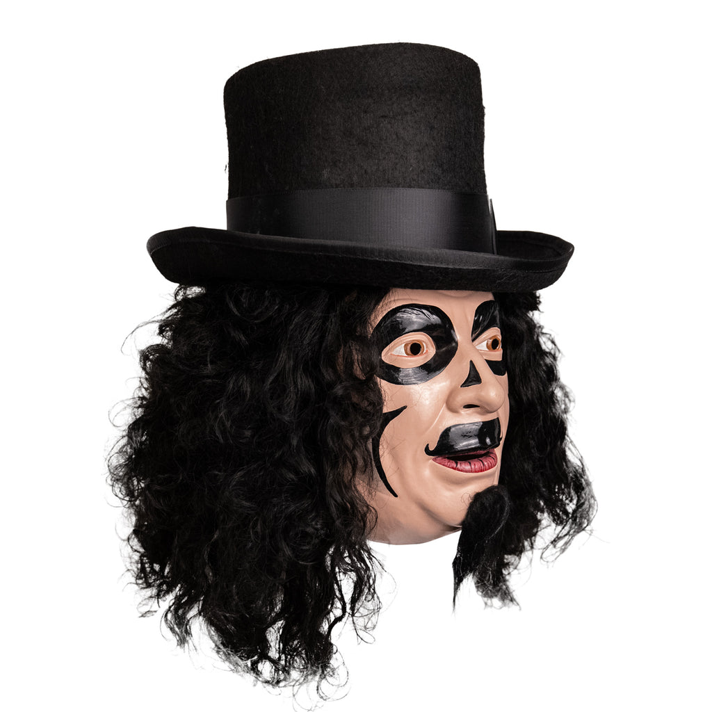 Mask, right side view. Man, long, black, curly hair, black top hat, long black goatee, brown eyes. Black face paint, circles around eyes, small triangles on either side of bridge of nose, curved lines on cheeks, large painted on moustache.