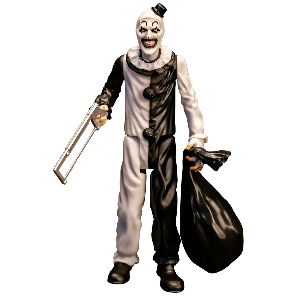 Terrifier, 5 inch figure, front view. Evil grinning clown face with tiny black top hat, black and white, jumpsuit, ruffle at neck, fingerless white gloves, black shoes. holding saw in right hand, black trash bag in left hand.