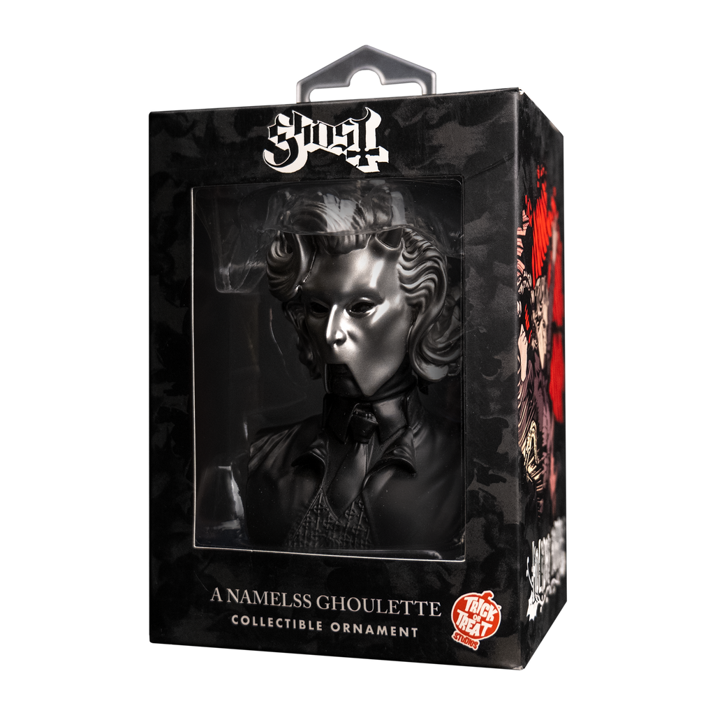 Product packaging, black window box with Ghost, Nameless Ghoulette ornament inside. Head neck and chest of woman, wearing chrome facemask with horns on face. Black shirt, tie and vest under black jacket. Text on box reads Ghost, A Nameless Ghoulette, collectible ornament. Orange and white Trick or Treat Studios logo