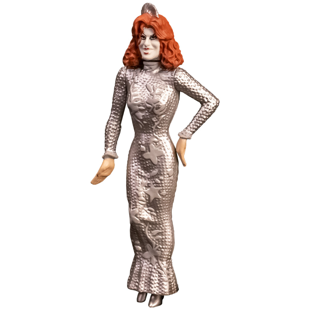 Action figure, front view. Showtime Baby Firefly, woman with red hair, pale makeup, wearing long sleeved floor length silver dress.
