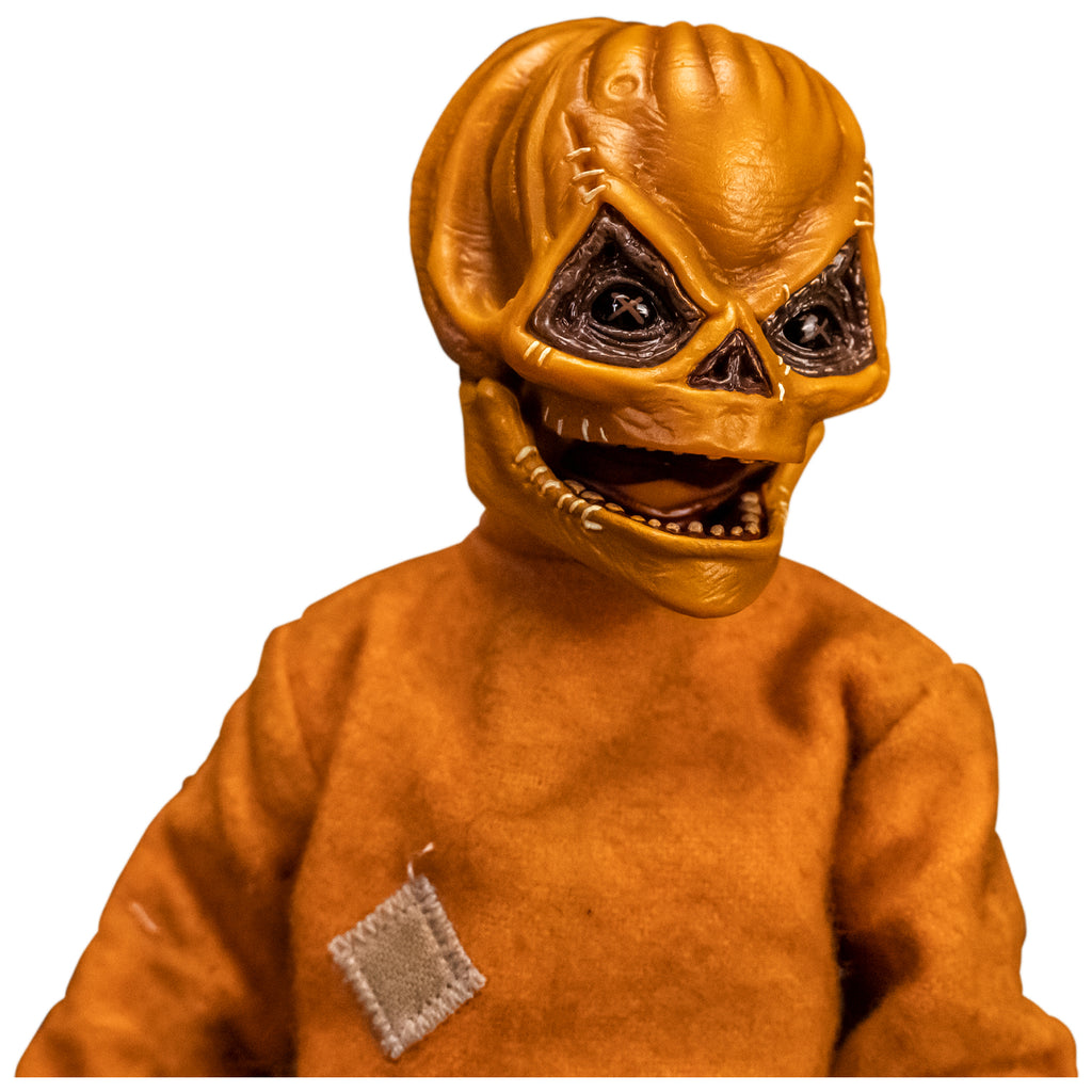 Right view. Close up of upper body and head of Trick 'r Treat Sam 1/6 scale figure with Sam Unmasked head. Head is Skull-like jack o' lantern face, stitches above eyes and sides of mouth, mouth open in grin. Wearing orange footy pajamas