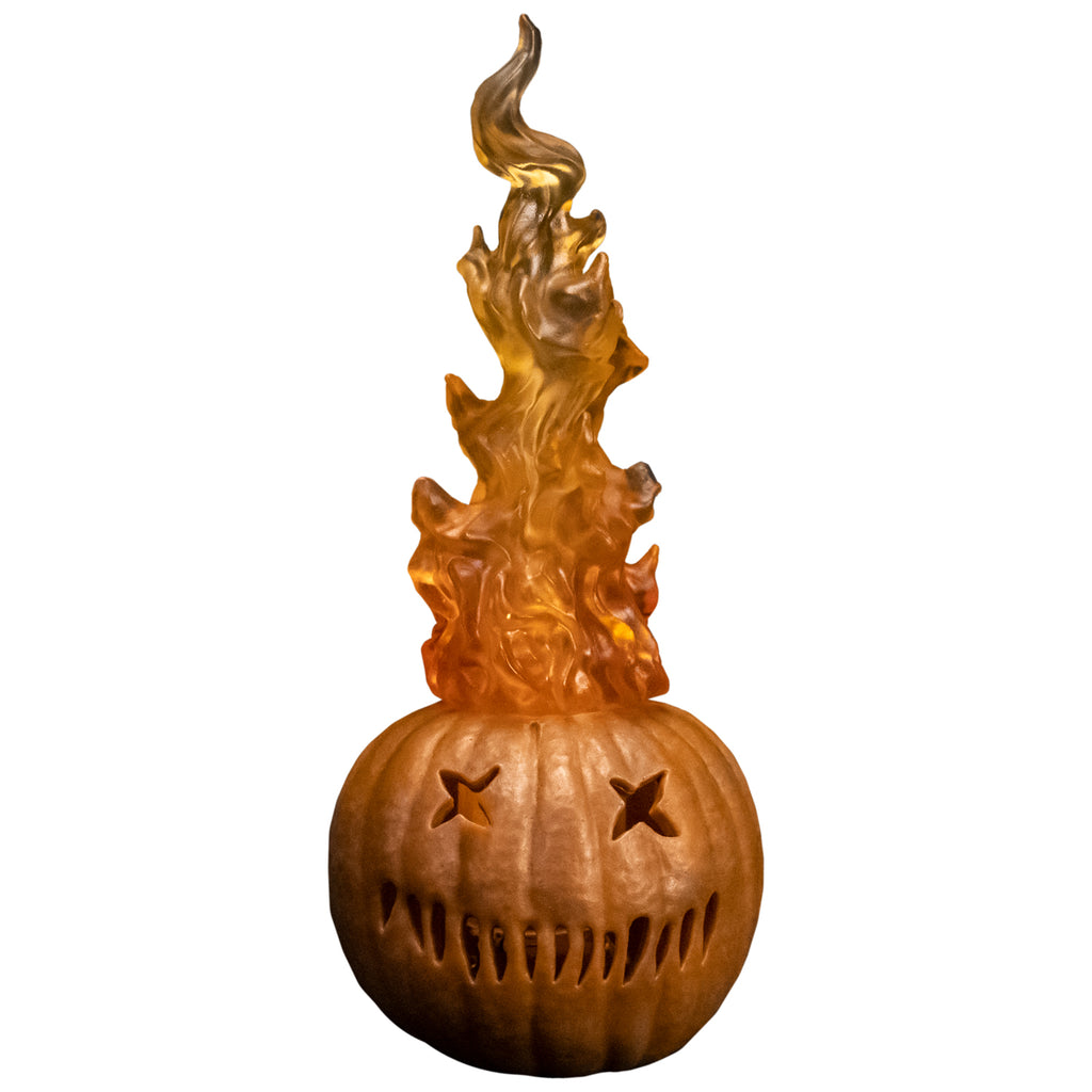 Sam 'o lantern prop. Orange jack o' lantern with flames coming out the top, two x eyes, several straight hash marks for mouth.