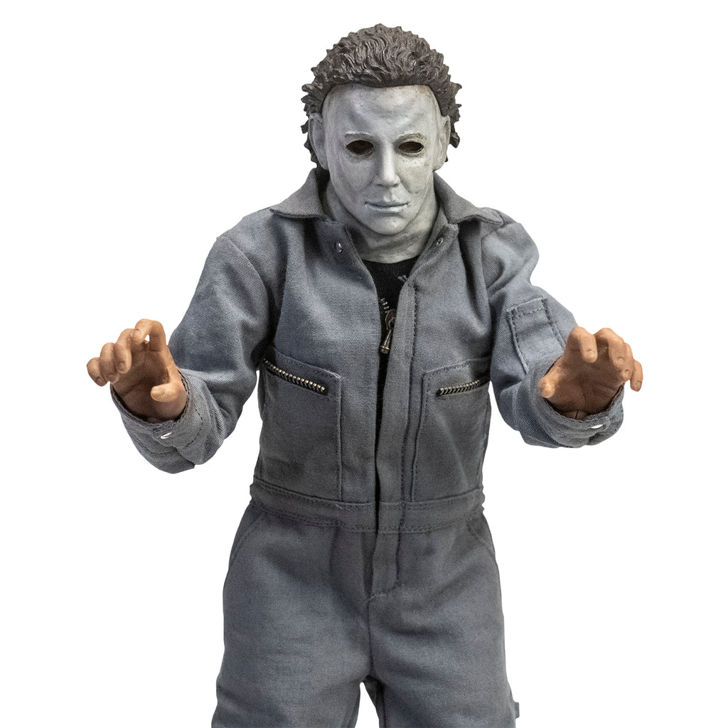 Front view. Halloween 6 Michael Myers 12" figure. White mask brown hair, wearing coveralls, hands reaching out.