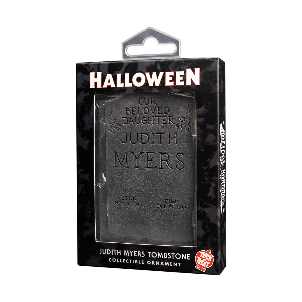 Product packaging, black window box, showing ornament. White text reads Halloween, Judith Myers Tombstone, collectible ornament. Orange and white Trick or Treat Studios logo.
