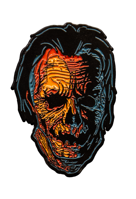 Enamel pin.  Head and neck of Jacob Atkins. Wrinkled orange Jack o' lantern-like face with black hair, gray highlights.