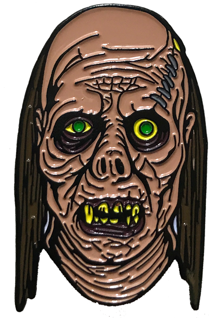 Enamel Pin.  Balding ghoul face, long brown stringy hair.  wrinkled skin, stitches in left forehead.  Black circles around green and yellow eyes.  Pug nose.  mouth with broken yellow teeth.
