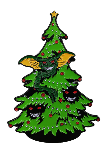 Enamel pin.  Christmas tree with gremlin peeking out, two grinning face with red eyes hidden in branches.