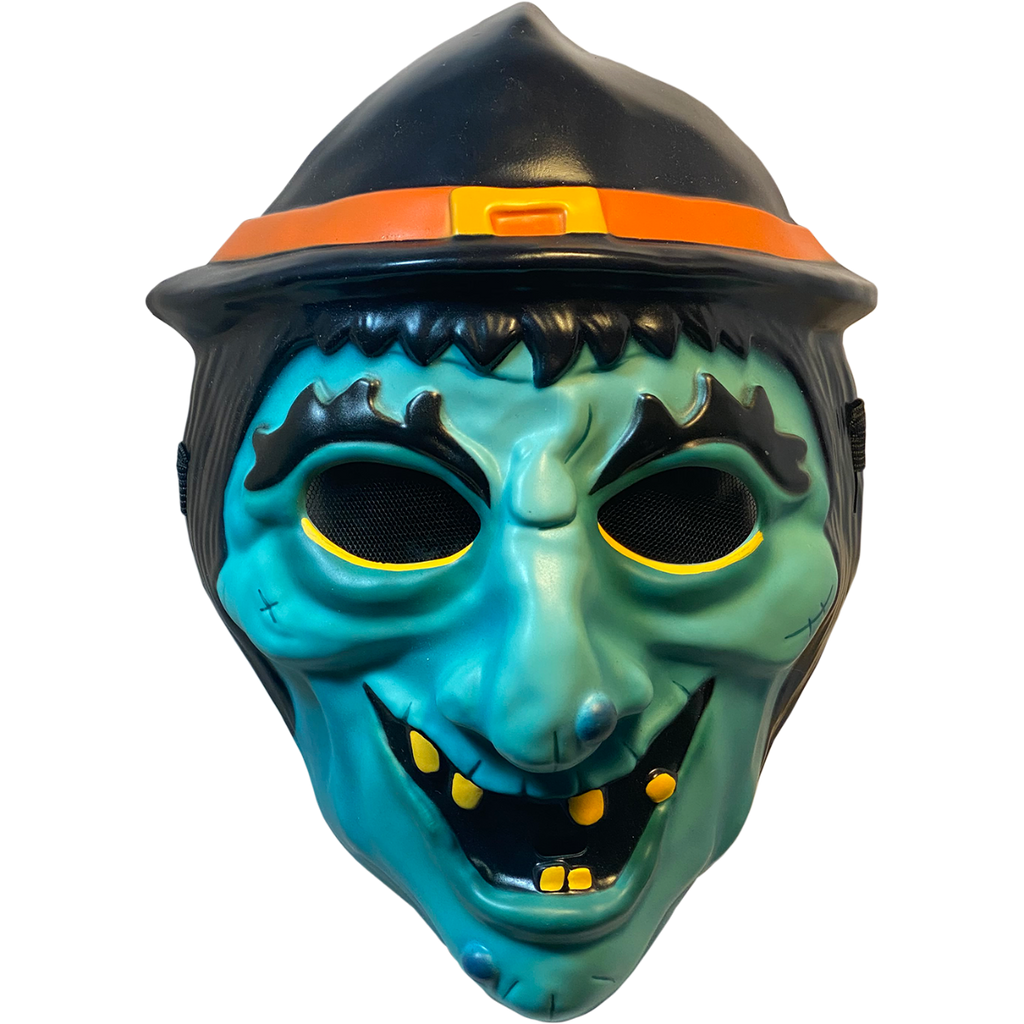 Plastic mask, front view. Green witch face. Black hair, eyebrows and eyes. Black witch hat with orange band and yellow buckle. Yellow eyeliner under eyes. Grinning mouth with sparse yellow teeth. 