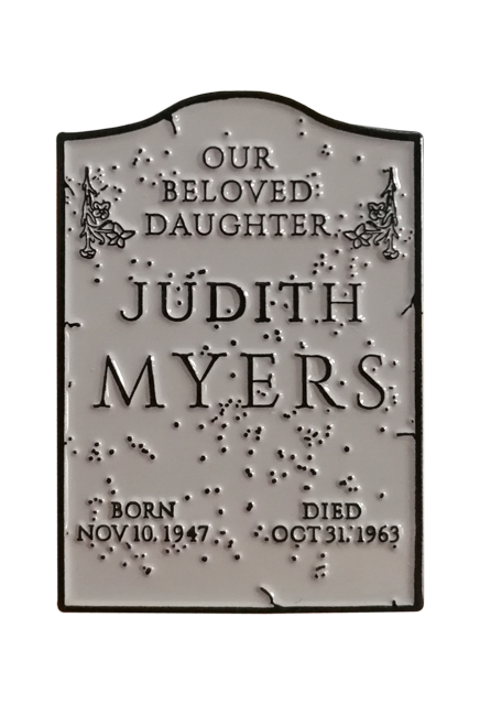 Halloween enamel pin. Gray tombstone, text reads, Our Beloved Daughter, Judith Myers, Born Nov 10 1947, Died Oct 31 1963.