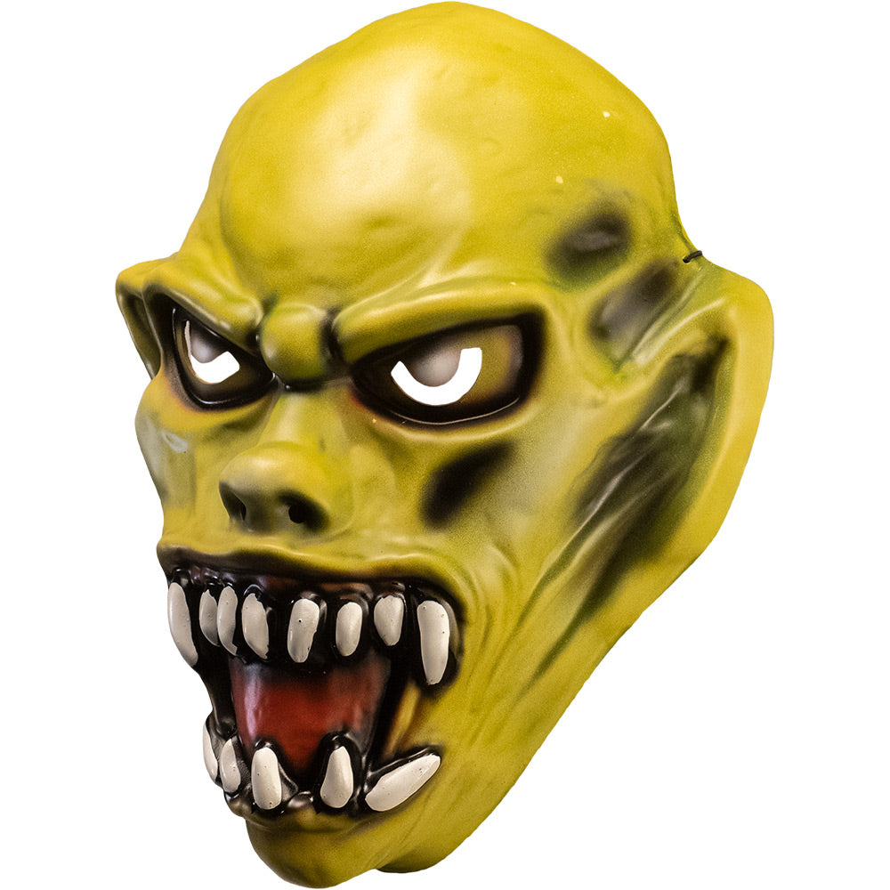 Vacuform plastic mask, left side view. Yellow skin. Angry face with large ears, yellow eyes, large snarling mouth with sharp white teeth.