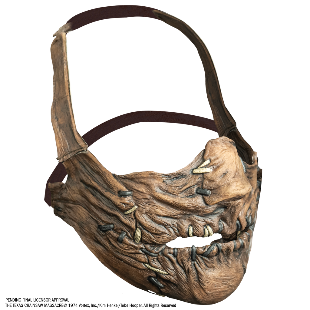 mask, right view. Lower face only, with strap that goes from cheeks around the back of the head, and strap that goes around the back of the lower part of the head. . lower face wrinkled flesh sewn together at nose, sides of mouth and lips